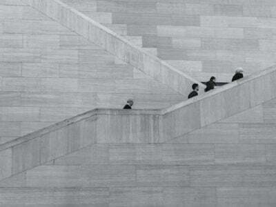 four person walking up a stair. black and white photo